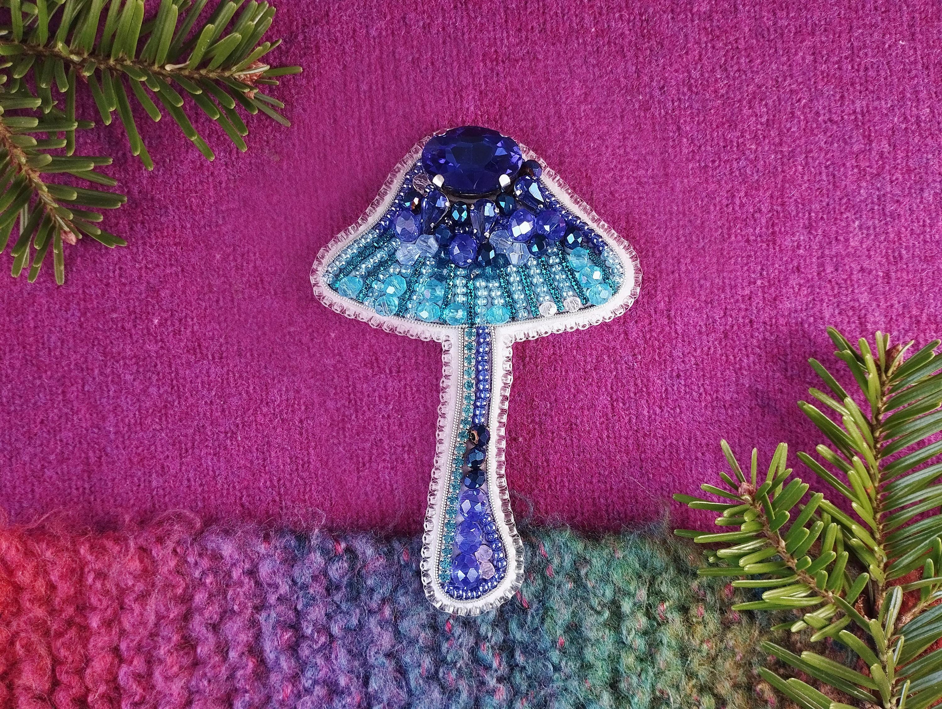 a knitted object with a blue mushroom on it